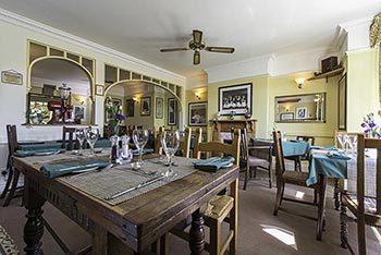 Paysanne dining room with tables set for dinner